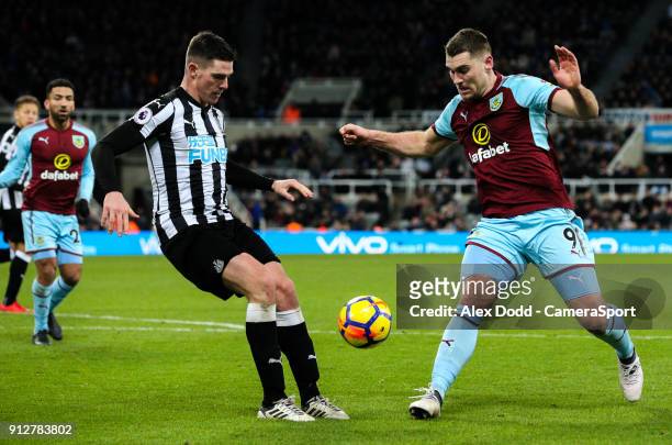 Burnley's Sam Vokes takes on Newcastle United's Ciaran Clark during the Premier League match between Newcastle United and Burnley at St. James Park...