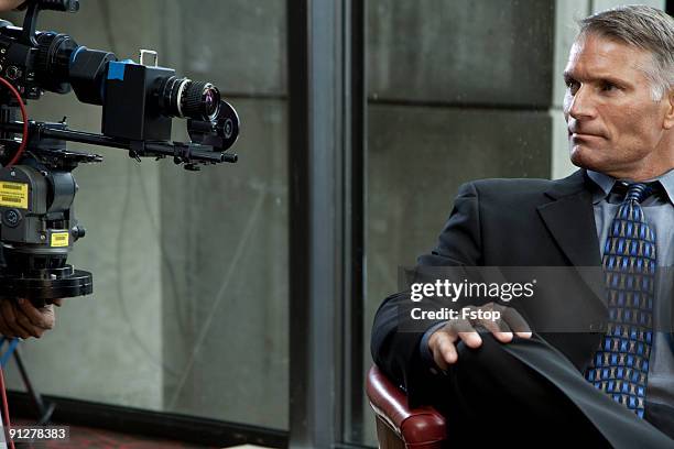 a businessman in front of a video camera  - 10004003 stock pictures, royalty-free photos & images