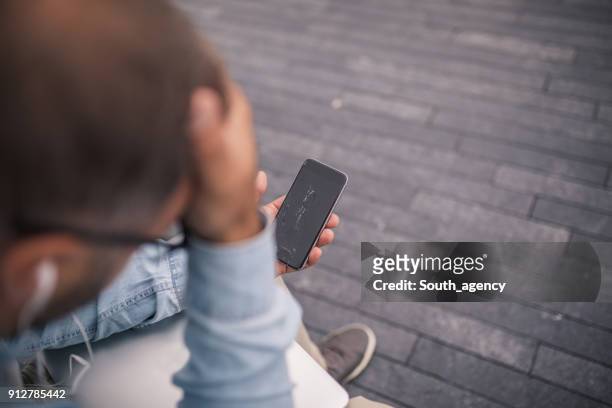 displeased man with broken smartphone - break stock pictures, royalty-free photos & images