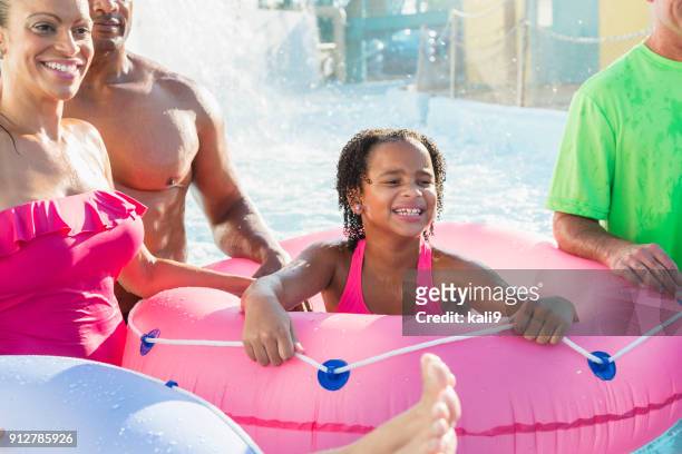 girl with family at water park - lazy river stock pictures, royalty-free photos & images