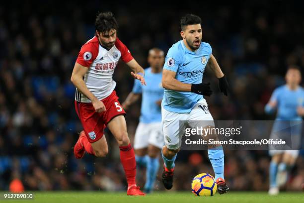 Sergio Aguero of Man City battles with Claudio Yacob of West Brom during the Premier League match between Manchester City and West Bromwich Albion at...