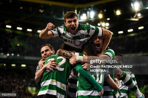 Sporting players celebrate after Sporting's French defender Jeremy Mathieu scored during the Portuguese league football match between Sporting CP and...