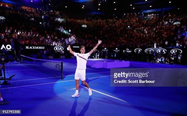 Roger Federer of Switzerland waves to the crowd as he leaves the court with the Norman Brookes Challenge Cup after winning the 2018 Australian Open...