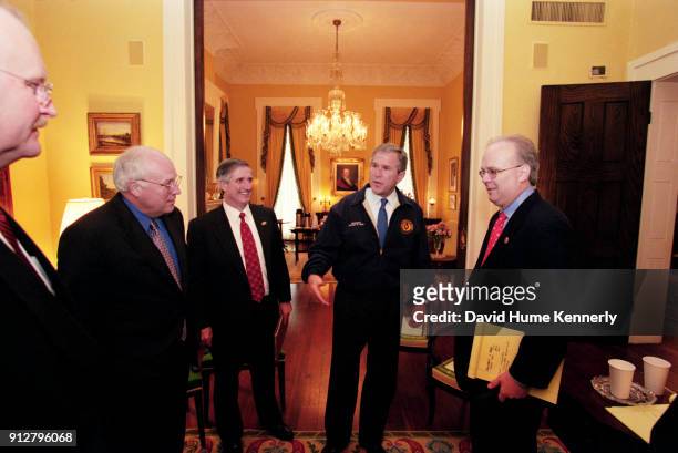 Texas Governor George W Bush talks with running mate Dick Cheney and advisers Joe Allbaugh, Karl Rove, and Andrew Card at the Governor's Mansion the...