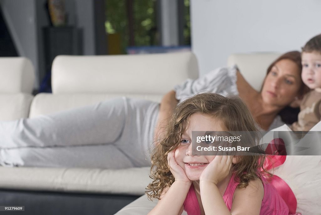 Smiling girl and family on sofa