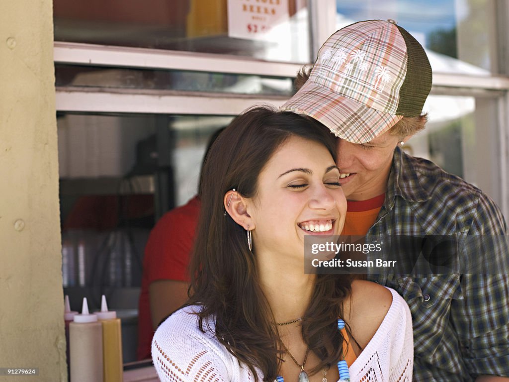 Smiling couple at food stand