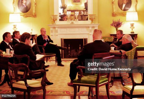 Texas Governor George W Bush talks with running mate Dick Cheney and advisers Karen Hughes, Don Evans, Karl Rove, Joe Allbaugh, and Andrew Card at...