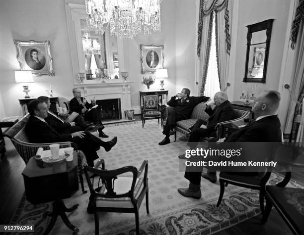 Texas Governor George W Bush talks with running mate Dick Cheney and advisers Karen Hughes, Don Evans, Karl Rove, Joe Allbaugh, and Andrew Card at...