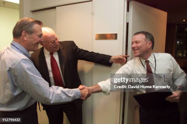 Vice Presidential candidate Dick Cheney introduces Don Rumsfeld to campaign adviser Scooter Libby at the transition headquarters on December 1, 2000...