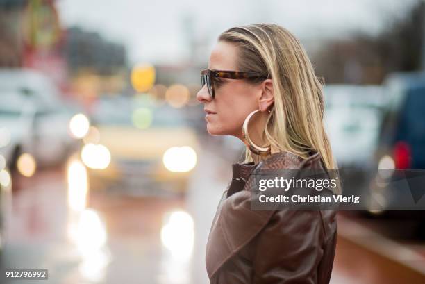 Celine Aagaard wearing brown leather coat, white boots outside Freya Dalsjo during the Copenhagen Fashion Week Autumn/Winter 18 on January 31, 2018...