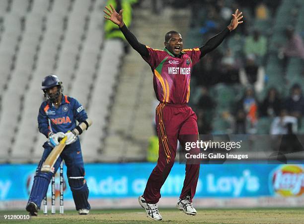 David Bernard of the West Indies appeals for lbw but Dinesh Kartik of India given not out during The ICC Champions Trophy Group A Match between India...