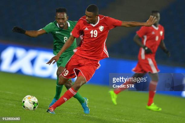 Nigeria's Abdullahi Musa vies for the ball with Sudan's Mohamed Ahmed Bashir Abdellh duringtheir African Nations Championship semifinal match at...
