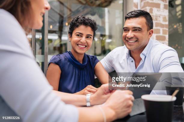 happy couple receive good news from professional businesswoman - happy customer stock pictures, royalty-free photos & images
