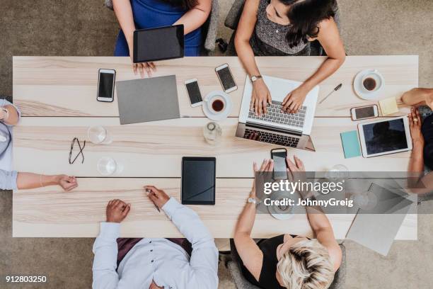 overhead view of business meeting - overhead view of meeting stock pictures, royalty-free photos & images