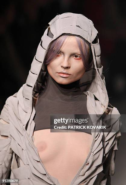 Model presents an outfit by British designer Gareth Pugh during ready-to-wear spring-summer 2010 fashion show in on September 30, 2009 in Paris. AFP...