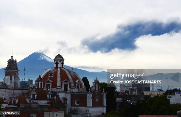 Ash spews from the Popocatepetl volcano as seen from the "Nuestra Senora del Carmen" church in Puebla, Mexico, on January 31, 2018. According to the...