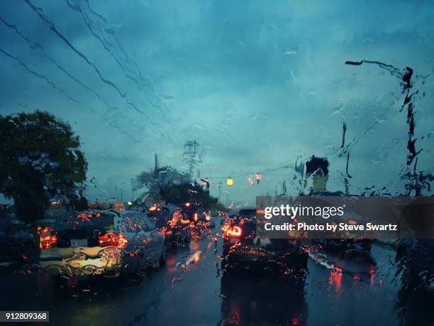 rainy autumn commute - driving rain stock pictures, royalty-free photos & images