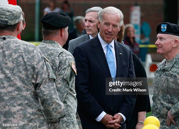 Vice President Joe Biden talks with members of the Delaware Army National Guard 261st Signal Brigade during a welcome home ceremony honoring the...