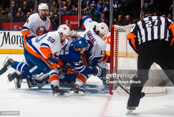 Kasperi Kapanen of the Toronto Maple Leafs scores on Thomas Greiss of the New York Islanders as Adam Pelech and Mathew Barzal of the New York...