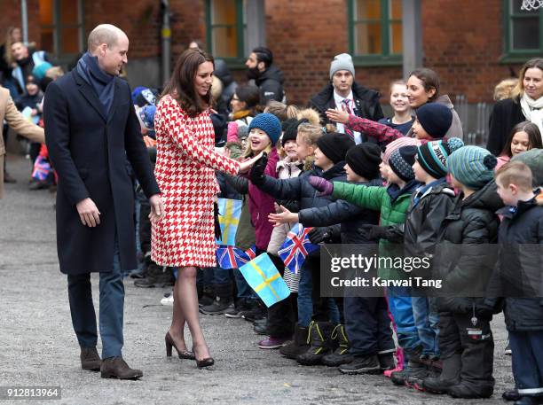 Catherine, Duchess of Cambridge and Prince William, Duke of Cambridge depart from Matteusskolan School after visiting children who have taken part in...