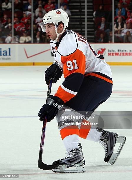 John Tavares of the New York Islanders skates against the New Jersey Devils during their preseason game at the Prudential Center on September 29,...