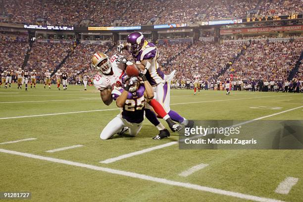 Tyrell Johnson and Madieu Williams of the Minnesota Vikings break up a long pass during the game against the san Francisco 49ers at Hubert H....