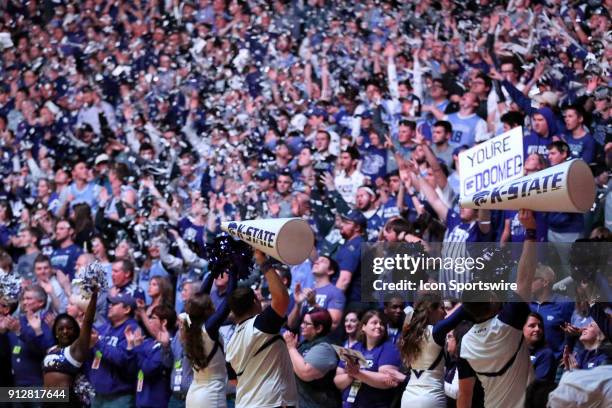 Kansas State fans throw newspaper clippings during player introductions before a Big 12 matchup between the Kansas Jayhawks and Kansas State Wildcats...