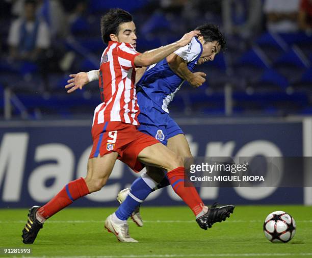 Atletico Madrid's midfielder Jose Manuel Jurado vies with FC Porto´s defender Jorge Fucile from Uruguay during the Group D UEFA Champions League...