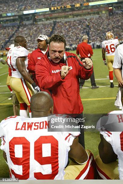 Defensive Line Coach Jim Tomsula coaches Manny Lawson of the San Francisco 49ers during the game against the Minnesota Vikings at Hubert H. Humphrey...