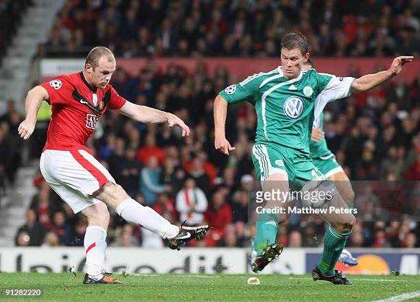Wayne Rooney of Manchester United has a shot during the UEFA Champions League match between Manchester United and Wolfsburg at Old Trafford on...