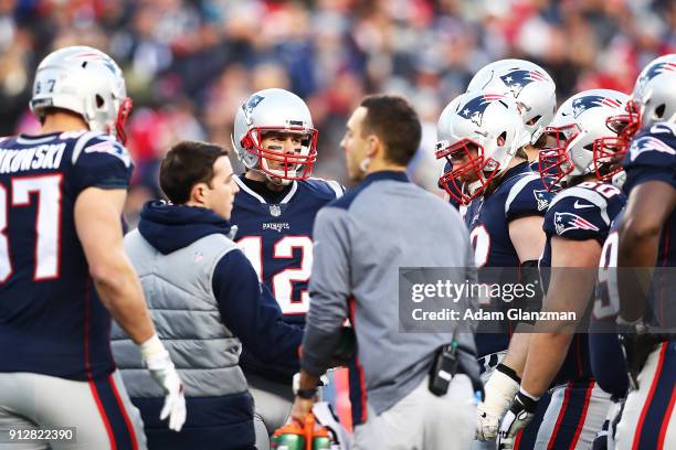 Tom Brady of the New England Patriots talks to his teammates during the AFC Championship Game at Gillette Stadium on January 21, 2018 in Foxborough,...