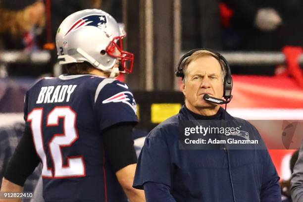 Head Coach Bill Belichick looks on as Tom Brady of the New England Patriots walks by during the AFC Championship Game against the Jacksonville...