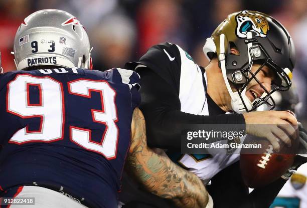 Blake Bortles of the Jacksonville Jaguars is tackled by Lawrence Guy of the New England Patriots in the third quarter during the AFC Championship...