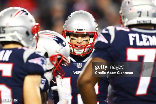 Tom Brady of the New England Patriots talks to his teammates during the AFC Championship Game at Gillette Stadium on January 21, 2018 in Foxborough,...