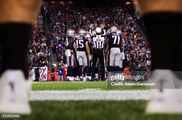 Members of the New England Patriots huddle during the AFC Championship Game against the Jacksonville Jaguars at Gillette Stadium on January 21, 2018...