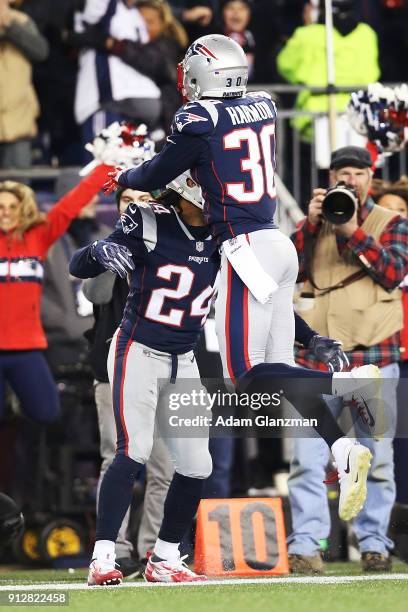 Stephon Gilmore and Duron Harmon of the New England Patriots react during the AFC Championship Game against the Jacksonville Jaguars at Gillette...