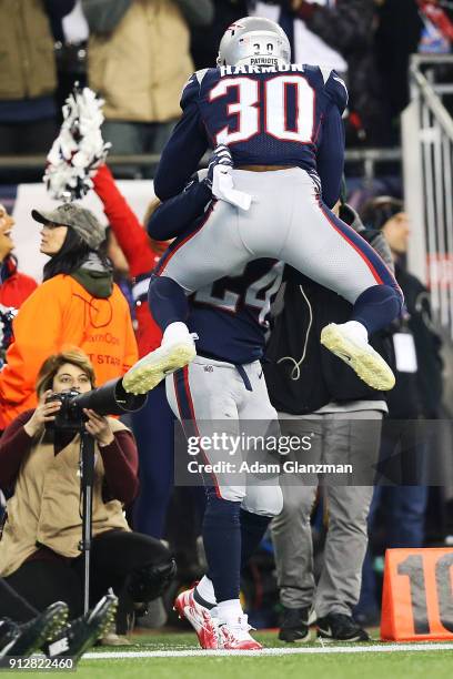 Stephon Gilmore and Duron Harmon of the New England Patriots react during the AFC Championship Game against the Jacksonville Jaguars at Gillette...