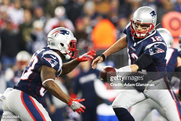 Tom Brady of the New England Patriots hands the ball off to during the AFC Championship Game against the Jacksonville Jaguars at Gillette Stadium on...