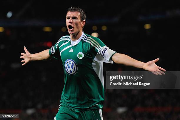 Edin Dzeko of VfL Wolfsburg celebrates scoring the opening goal during the UEFA Champions League Group B match between Manchester United and VfL...