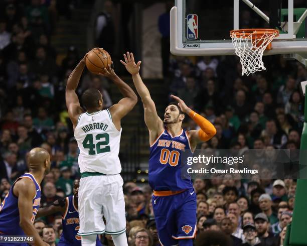 Al Horford of the Boston Celtics shoots over Enes Kanter of the New York Knicks during the second quarter of the game at TD Garden on January 31,...