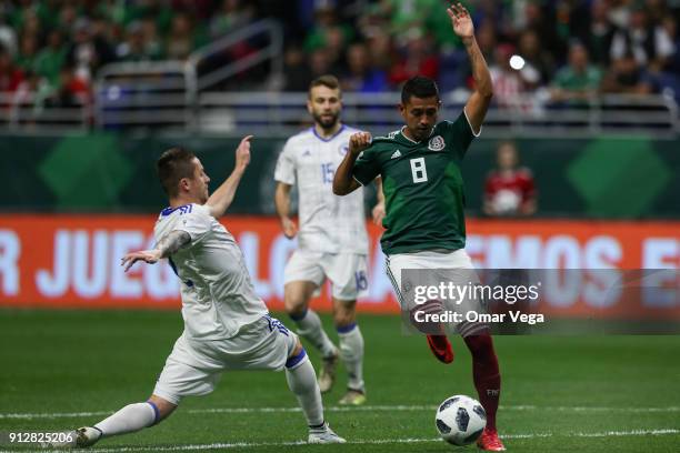 Elias Hernandez of Mexico fights for the ball with Almir Bekic of Bosnia during the friendly match between Mexico and Bosnia and Herzegovina at...