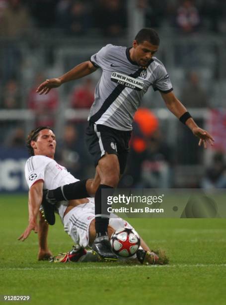 Mario Gomez of Bayern tackles Felipe Melo of Juventus during the UEFA Champions League Group A match between FC Bayern Muenchen and Juventus Turin at...