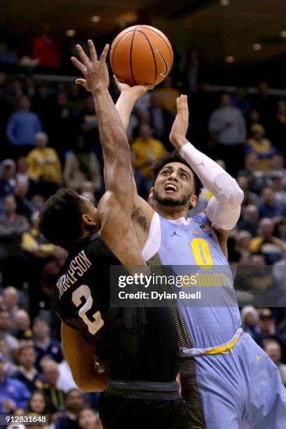 Markus Howard of the Marquette Golden Eagles attempts a shot while being guarded by Aaron Thompson of the Butler Bulldogs in the first half at the...