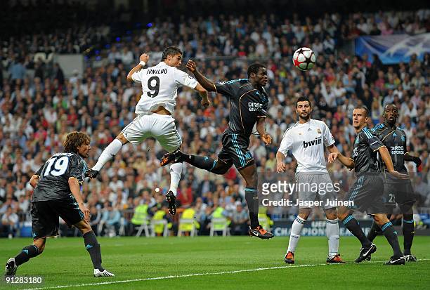 Cristiano Ronaldo of Real Madrid duels for the ball with Taye Taiwo of Marseille during the Champions League group C match between Real Madrid and...