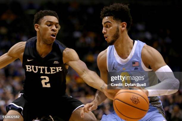 Markus Howard of the Marquette Golden Eagles dribbles the ball while being guarded by Aaron Thompson of the Butler Bulldogs in the first half at the...