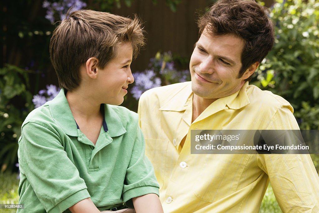 Father and son smiling at one another