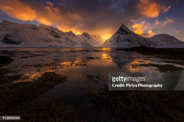 sunrise over lofoten snow mountain peaks - fjord der berge stock-fotos und bilder