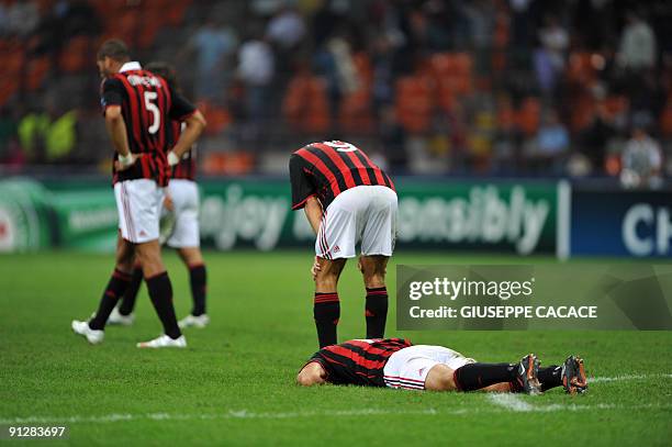 Milan's defender Gianluca Zambrotta A.C. Milan's forward Filippo Inzaghi and AC. Milan's defender Oguchi Onyewu react at the end of their Champions...