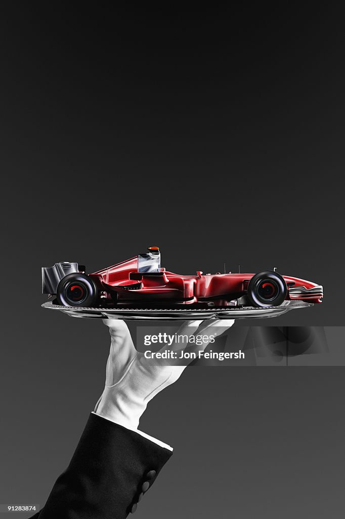 Open-wheel single-seater racing car race car on silver platter.