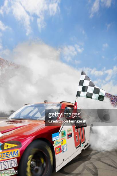 winning nascar driver doing a burnout. - nascar flag stock pictures, royalty-free photos & images